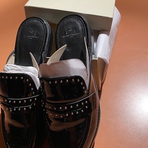 Marc Fisher black studded patent leather mules.
